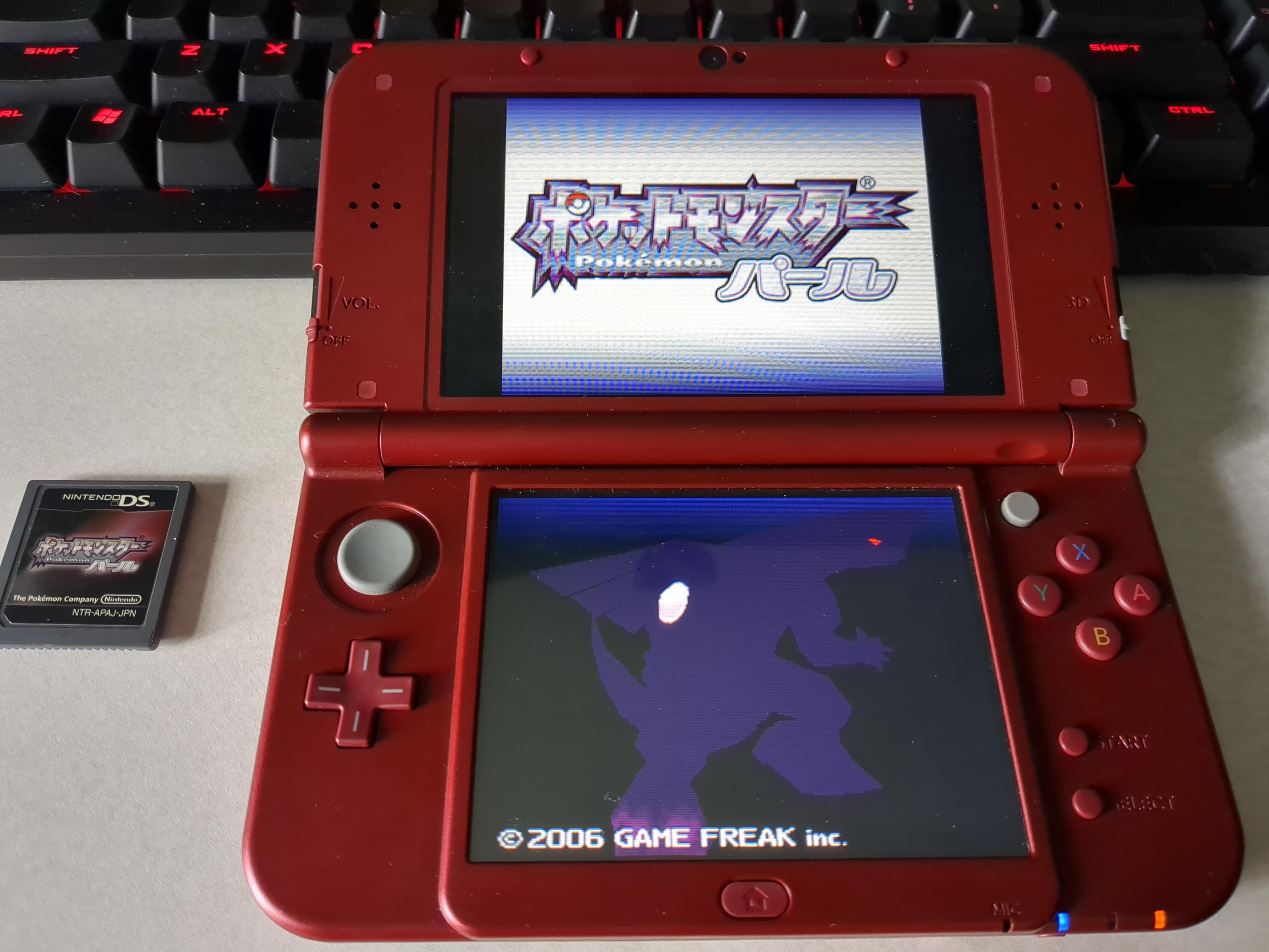 My New3DS playing a Pokemon Pearl ROM, and the cart I dumped the ROM from right next to it.